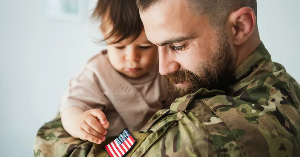 VA Loans Explained - veteran holding child