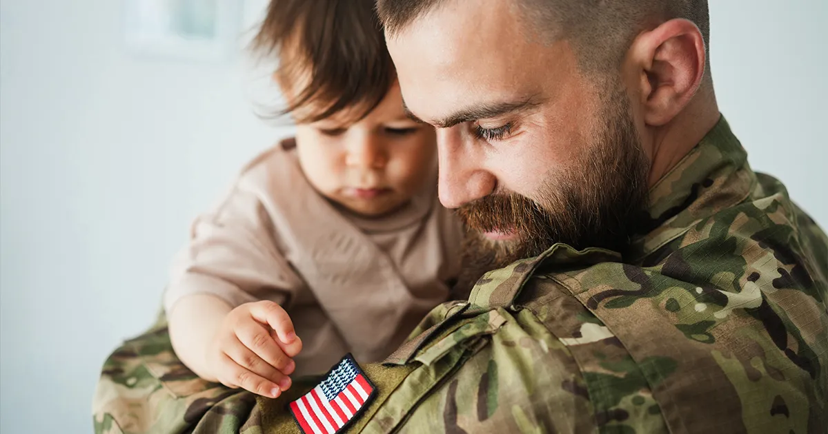 VA Loans Explained - veteran holding child
