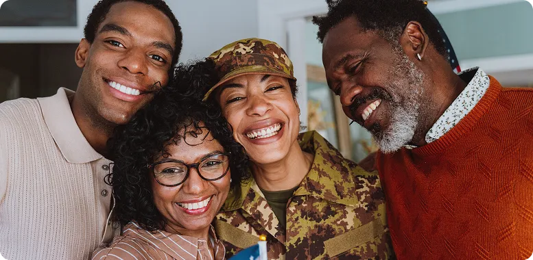 Veteran surrounded by family hugging