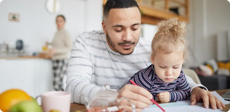 Father and child looking at a paper together