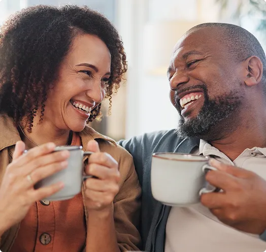 Couple smiling drinking coffee