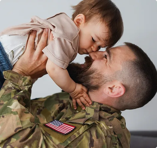 Veteran father holding child