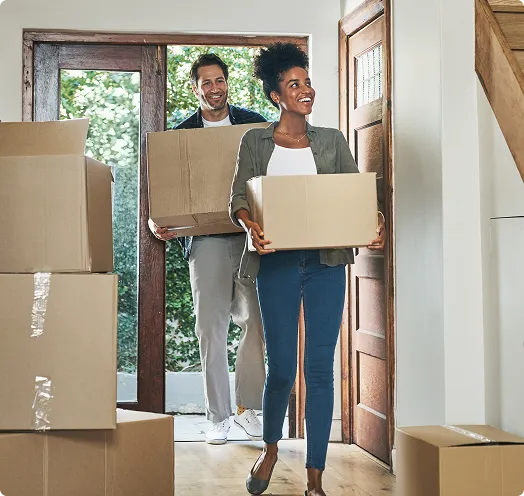couple with moving boxes entering new home - purchase loan