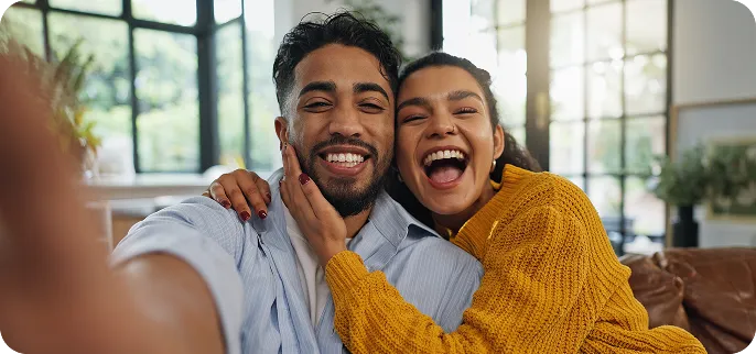 Happy couple taking a photo smiling
