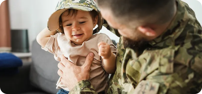 Veteran holding baby