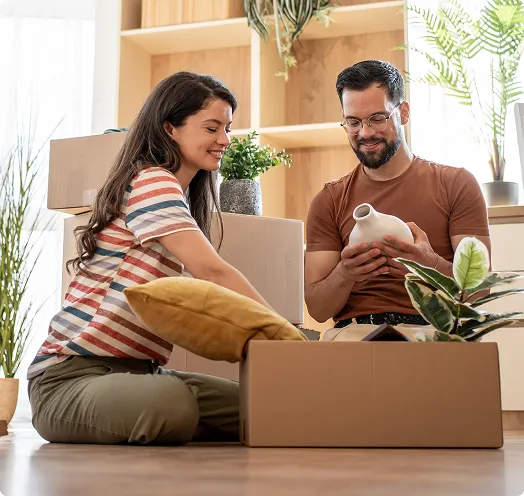 Couple unpacking boxes in home