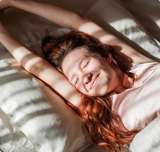 Woman stretching in bed