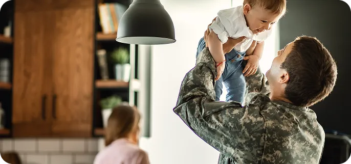 Veteran holding child