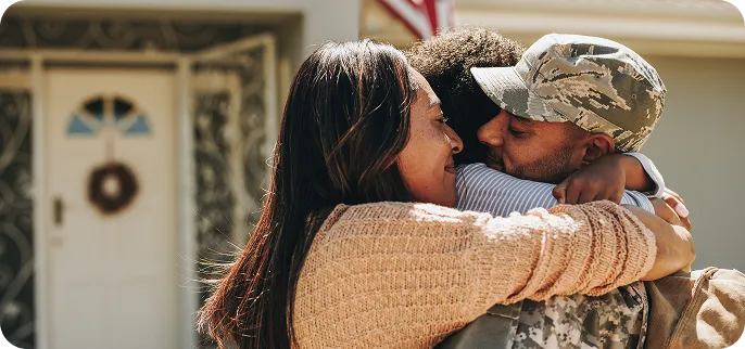 VA Loan Bulder - Veteran hugging wife and child
