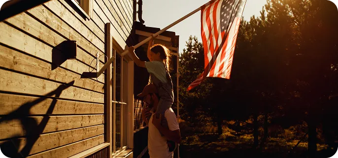 Father and Daughter putting up an American Flag - VA Loan