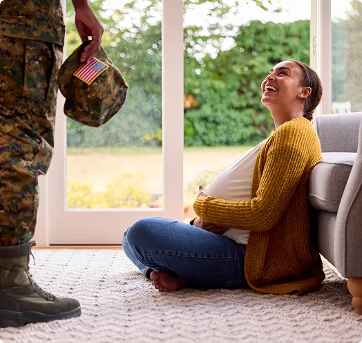 Pregnant woman looking up at veteran husband - VA Loan Builder