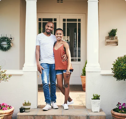 Couple standing in front of their home's front door