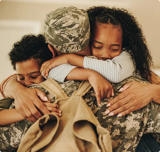 Army veteran hugging family - VA Loan Builder